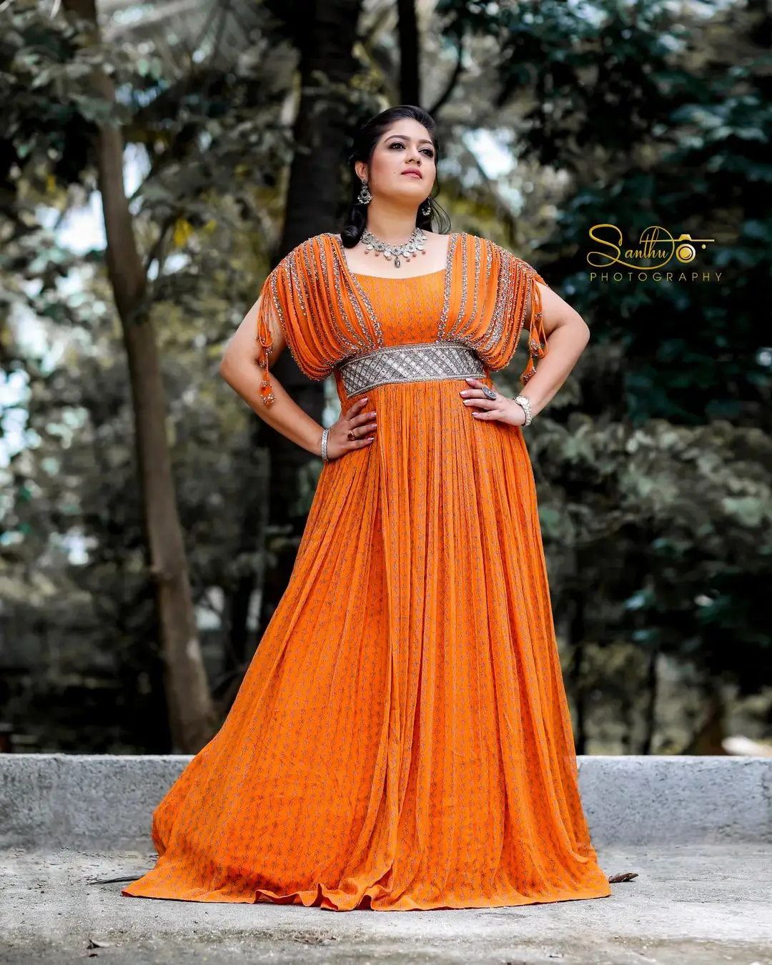 Meghana Raj Wearing Beautiful Earring Jewellery Orange Gown